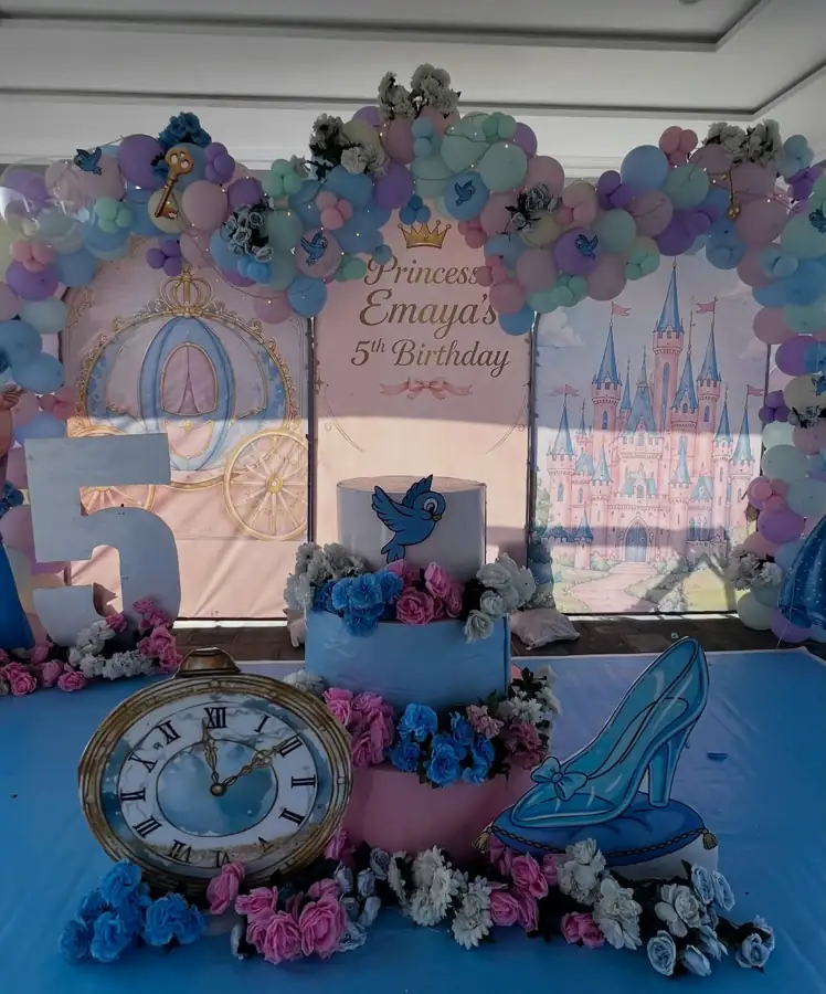 Cinderella themed birthday with a giant clock, a glass slipper and a pastel balloon arch