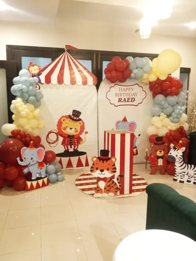 Circus tent birthday backdrop with a lion, tiger and elephant and red, grey and yellow balloons