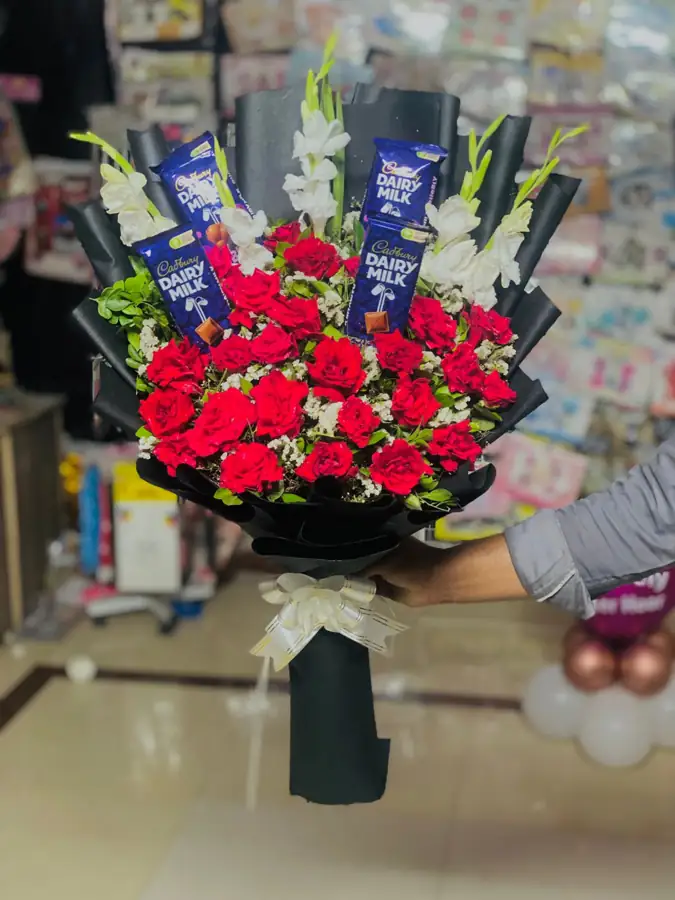 Hand-held red rose bouquet with white gladiolus in black wrapping