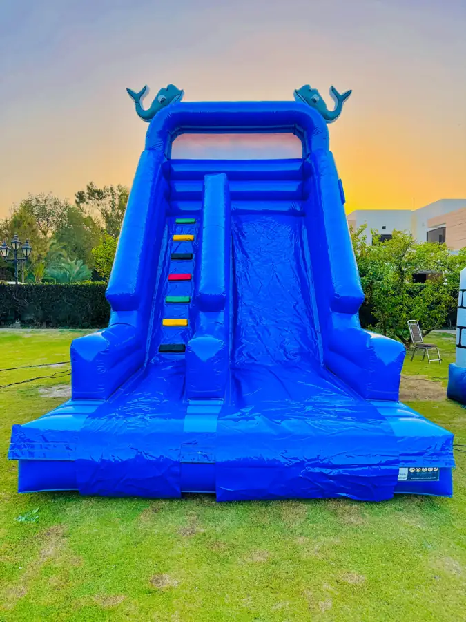 Tall blue inflatable slide on a lawn