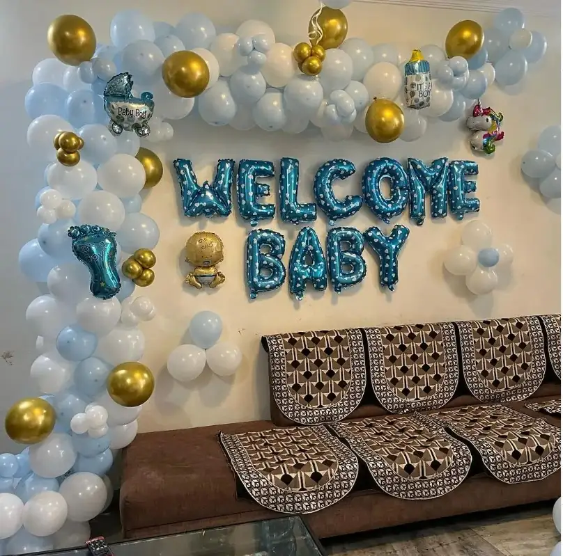 Welcome Baby foil letters on a wall covered in blue, white and gold balloons