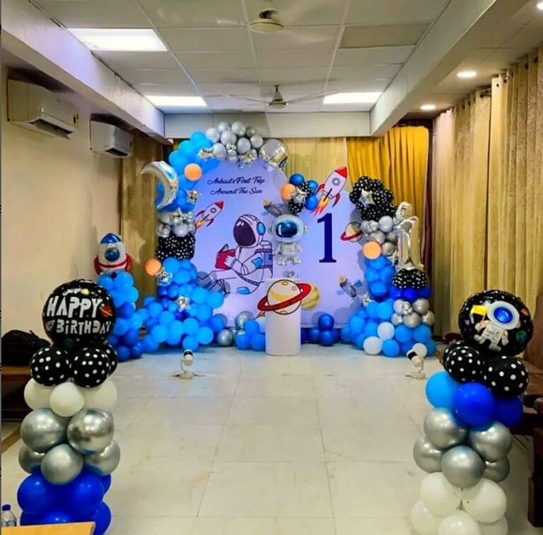 Astronaut and space theme first birthday with blue and black balloons
