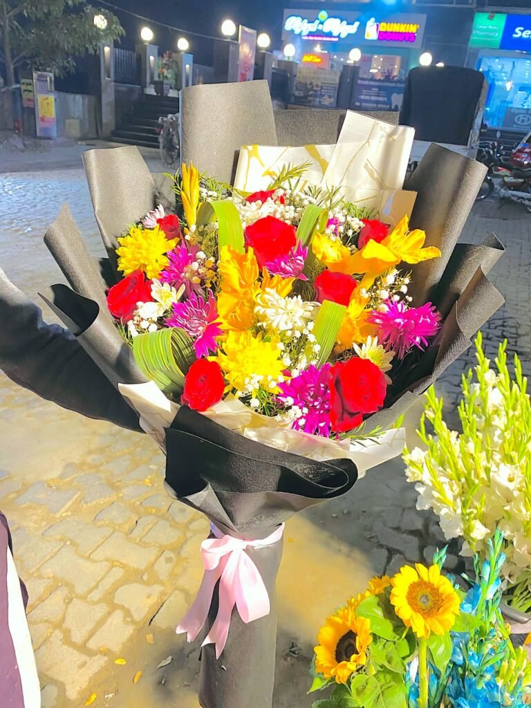 Large colourful flower bouquet in black and gold wrapping