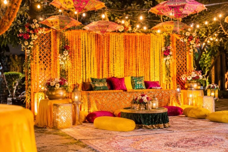Mehndi night stage with marigold flower backdrop, colourful umbrellas and string lights