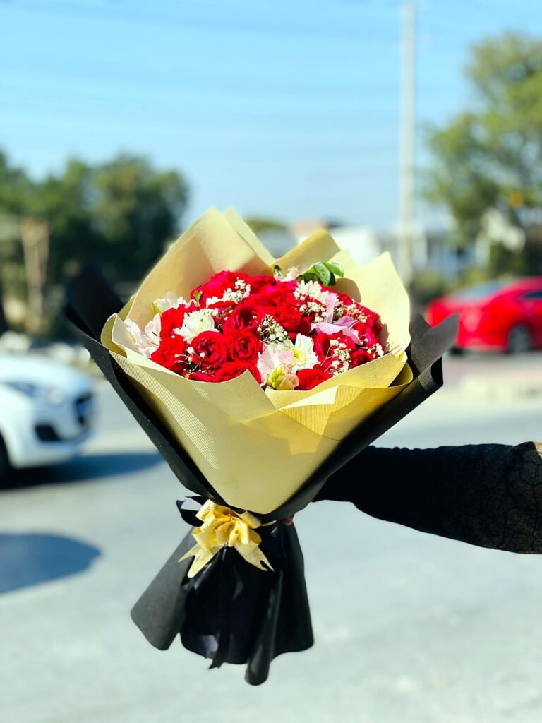 Red rose bouquet in cream and black wrapping